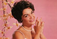 Studio portrait of American singer Connie Francis wearing a lavender and white spaghetti-strap dress.