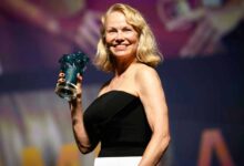 US actress Pamela Anderson poses holding her trophy after being awarded a Deauville Talent Award prize