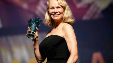 US actress Pamela Anderson poses holding her trophy after being awarded a Deauville Talent Award prize