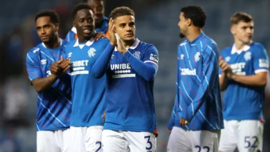 Max Aarons applauds the Rangers fans at the end of a game