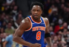 Nov 25, 2024; Denver, Colorado, USA; New York Knicks guard Jalen Brunson (11) reacts towards forward OG Anunoby (8) in the second quarter against the Denver Nuggets at Ball Arena. Mandatory Credit: Ron Chenoy-Imagn Images